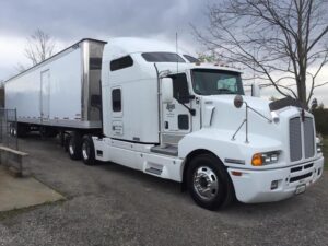 Yes, it was indeed Palmer Trucks that oversaw the Kenworth T600 that moved Kenny's band and stage equipment across the United States.